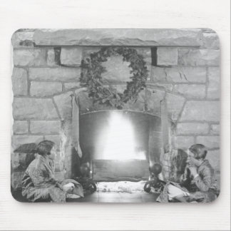 Two girls sitting by a fireplace at Christmas Mouse Pad