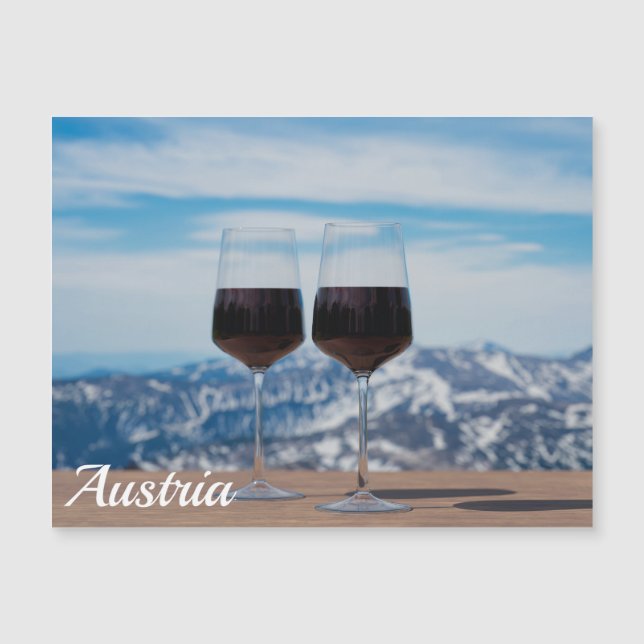 Two glasses of red wine against mountains (Front)
