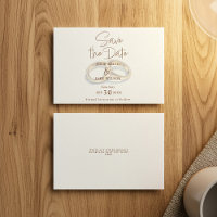 Two gold wedding rings muted save the date