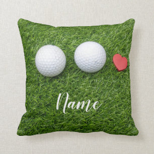 Two Golf balls and  love heart are on green grass Cushion