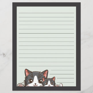Two grey kittens on lined with grey paper