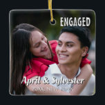 Two Hearts One Love Personalised Engagement Photo  Ceramic Ornament<br><div class="desc">Celebrate your engagement with this beautiful personalised photo ornament that captures the joy and romance of your special milestone. The front features your favourite engagement photo with elegant "ENGAGED" text and your names, while the back showcases another cherished moment together with the romantic message "Two hearts, one love, forever united."...</div>