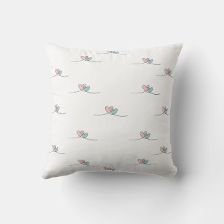 Two hearts with wings, one red and one blue cushion