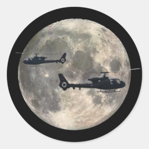 two helicopters silhouetted by a full moon classic round sticker