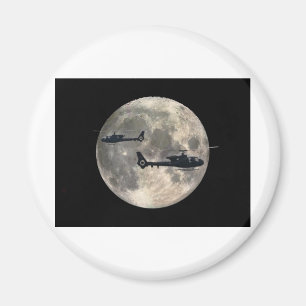 two helicopters silhouetted by a full moon magnet