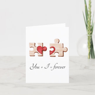 two matching puzzle pieces with a red heart Card
