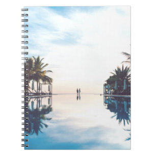 Two person standing beside swimming pool notebook