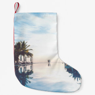 Two person standing beside swimming pool small christmas stocking