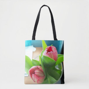 two pink tulips on an all-over printed tote bag
