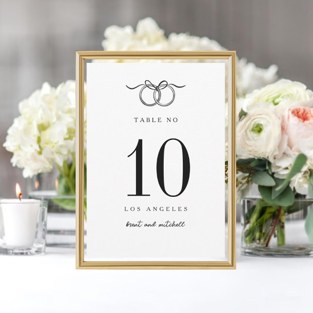 Two Rings tied with bow hand drawn table number (Creator Uploaded)