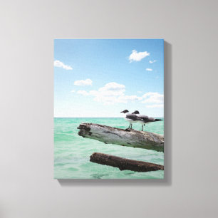 Two seagulls sitting on a dead tree sticking out canvas print