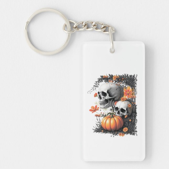 Two skulls and a pumpkin among flowers. key ring (Front)