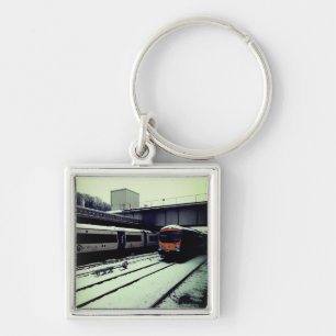 Two trains, in the snow key ring