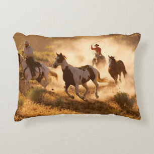 Two western cowboys riding horses, roping wild hor decorative cushion