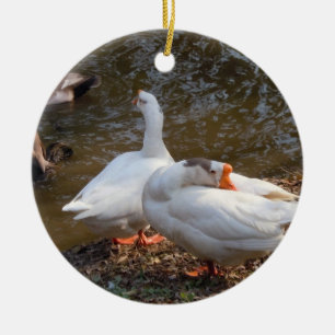 two white geese playing by a pond. ceramic tree decoration