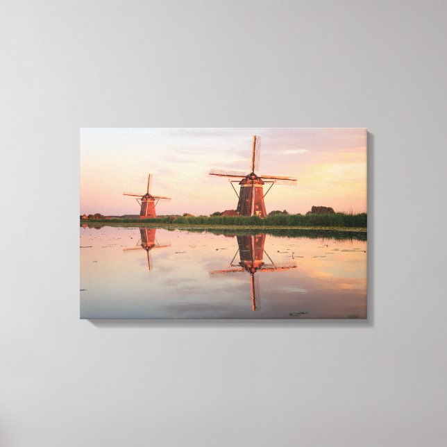 Two windmills with reflection at sunset canvas print (Front)