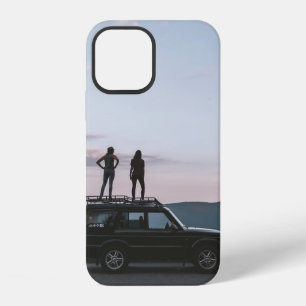 Two women standing on car's roof iPhone 12 case