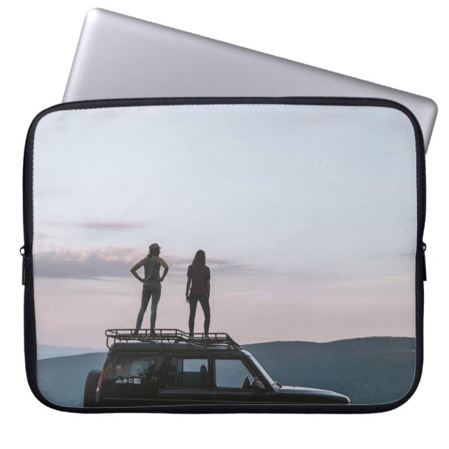 Two women standing on car's roof laptop sleeve (Front)