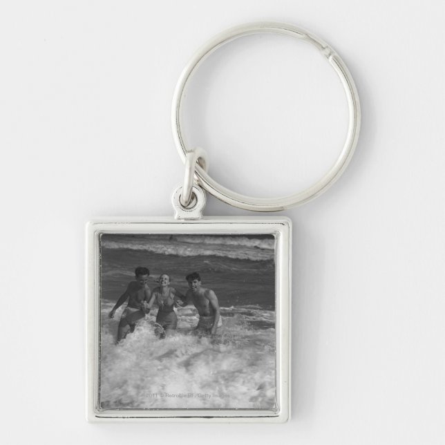 Two young men and woman playing in wave B&W Key Ring (Front)