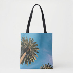 Twp palm trees under blue sky at daytime tote bag