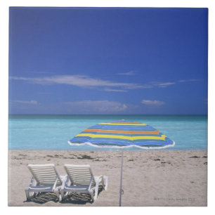 Umbrella and two lounge chairs on beach, Miami Tile