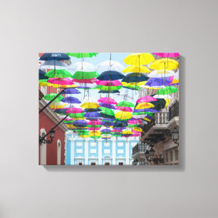 Umbrellas Above San Juan Streets and Mansion Canvas Print