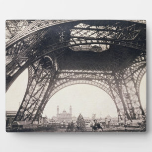 Under the Eiffel Tower, before ascending, from 'L' Plaque