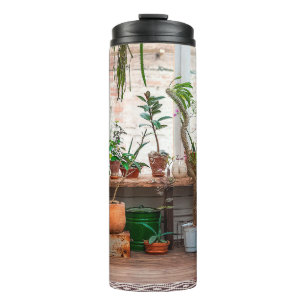 Urban jungle. Winter garden with plants, flowers. Thermal Tumbler