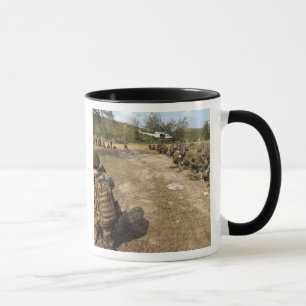 US Marines provide security as a UH-1N Mug