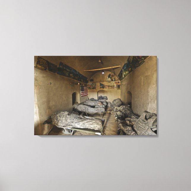 US Soldiers sleep in an abandoned mud house Canvas Print (Front)