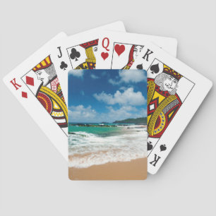 USA, Kauai, Hawaii. A Woman Strolls The Rocks Playing Cards