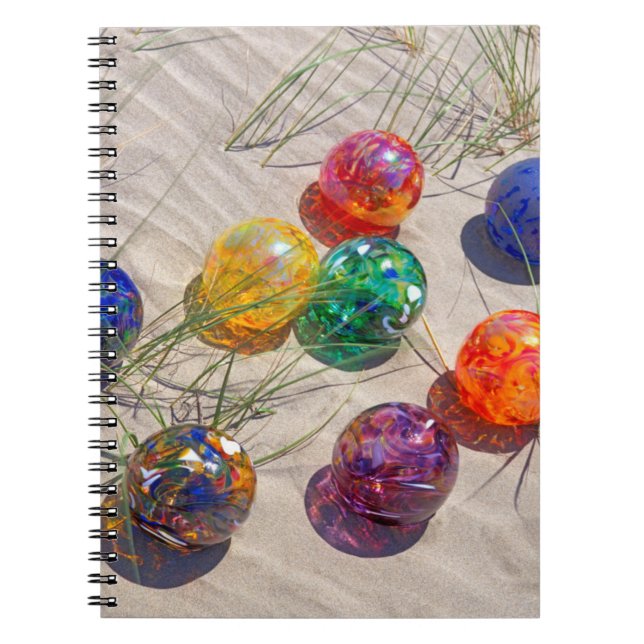 USA, Oregon. Colourful Glass Floats On Sand Dune Spiral Notebook (Front)