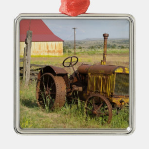USA, Oregon, Shaniko. Rusty vintage tractor in Metal Tree Decoration