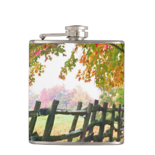 USA, Vermont. Fence under fall foliage. Hip Flask