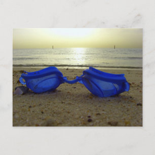 Vacation time, blue goggles at the beach postcard