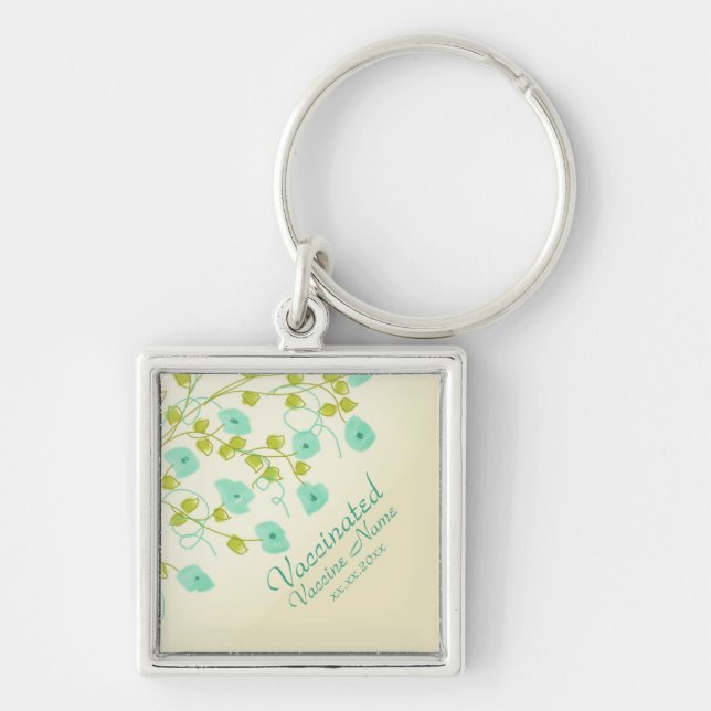 Vaccinated notification with teal flowered key ring (Front)