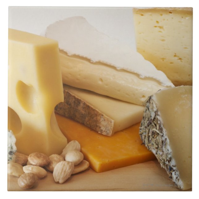Various cheeses on chopping board tile (Front)