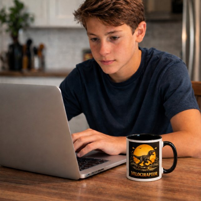 Velociraptor Dinosaur Prehistoric Moon Mug (Teen boy working on his laptop with a Velociraptor mug)