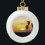 Venice Beach California Sunset Souvenir Ceramic Ball Christmas Ornament<br><div class="desc">This photographic image shows tall palm trees in silhouette standing against a gorgeous vivid yellow, golden, orange, and red sunset over the Pacific Ocean in Venice Beach, California. Add optional text or your vacation dates for a one of a kind unique souvenir. Another original exclusive design by Sonja Quidama Image...</div>