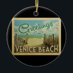 Venice Beach Vintage Travel Ceramic Tree Decoration<br><div class="desc">This Greetings From Venice Beach vintage postcard design features a sandy beach with a beautiful turquoise ocean water and above the sea,  a blue sky with billowy white clouds. In vintage travels style.</div>