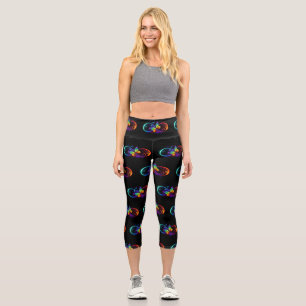 Vibrant infinity with rainbow butterfly on black capri leggings