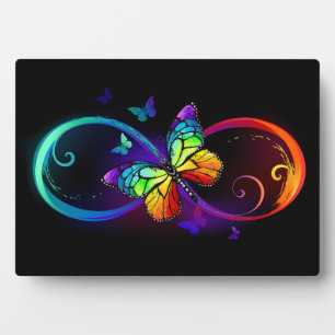 Vibrant infinity with rainbow butterfly on black plaque