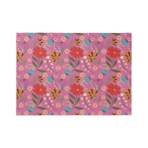 Vibrant pink rug with red, blue and orange flowers