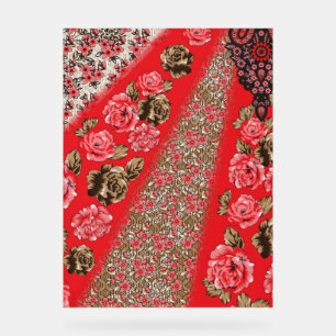 Vibrant red fabric featuring intricate floral and acrylic sign