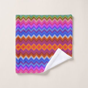 Vibrant towels hang on a rod, featuring a colourfu