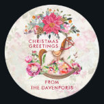 Victorian Rocking Horse & Poinsettia Christmas Classic Round Sticker<br><div class="desc">Festive Christmas stickers with the text Christmas Greetings. The background is a vintage style collage with a faded image of pink roses,  green leaves and french writing. Layered over top is a pretty poinsettia christmas bouquet and a victorian rocking horse surrounded with pretty pink peonies and posies.</div>