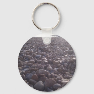 View over pebbles to silouetted West Pier Key Ring