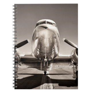 vintage aeroplane on a runway notebook
