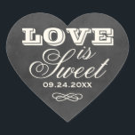 Vintage Black Chalkboard Love is Sweet Wedding Heart Sticker<br><div class="desc">Whimsical wedding favour stickers in a heart shape feature "Love is Sweet" with a monogram of the bride and groom names and wedding date and with a soft white chalk appearance on a rustic black board background with textured look.</div>
