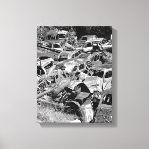 Vintage cars rusting away in a car yard canvas print
